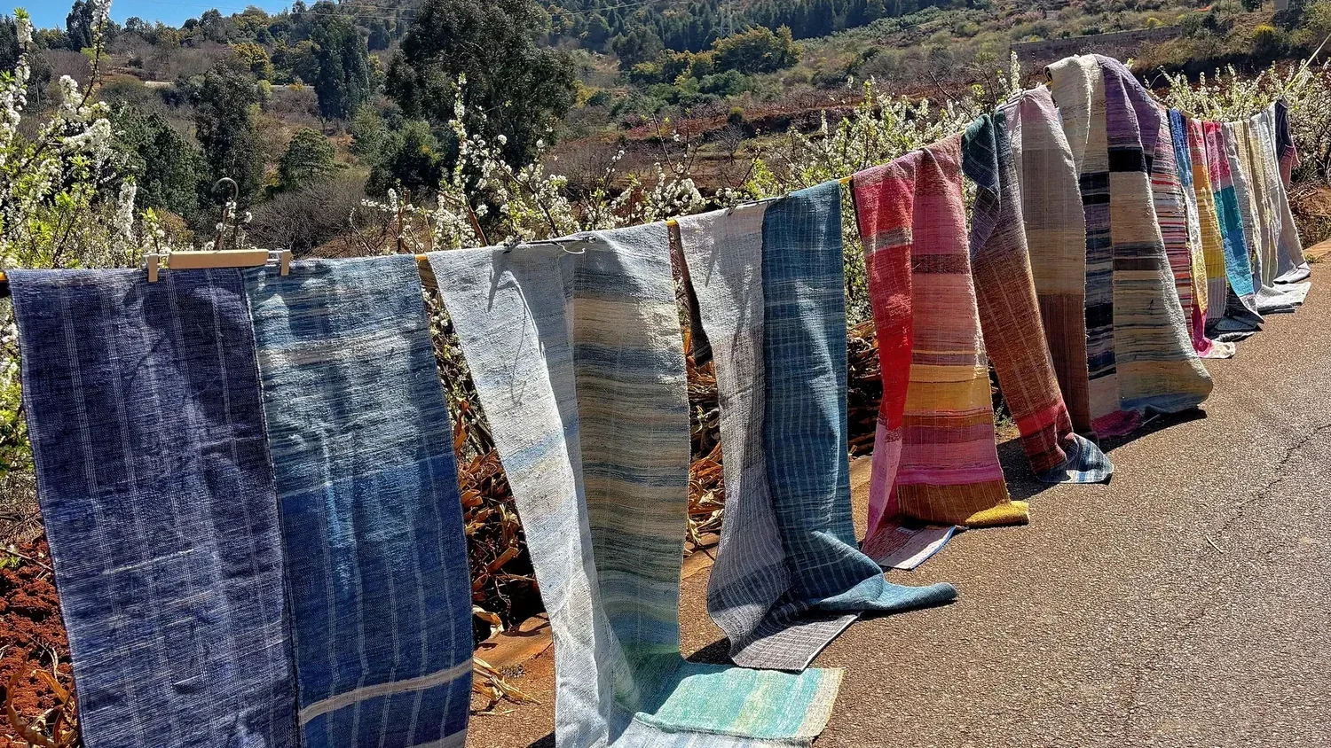 An illustrative landscape of striped textiles displayed outdoors